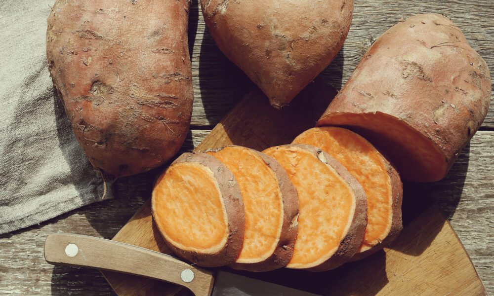 Sweet potato on the wooden table | https://fruitsauction.com/