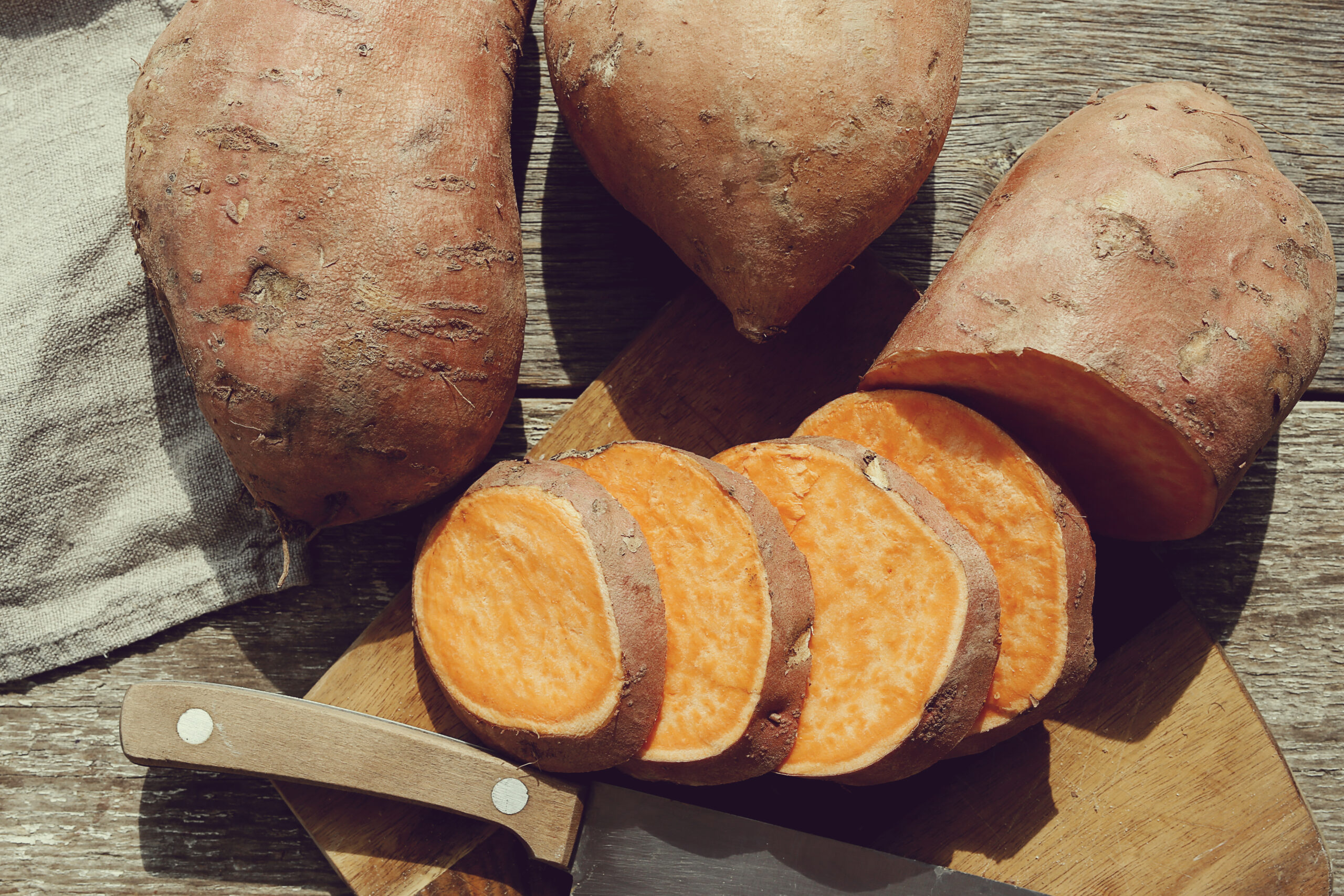 Sweet potato on the wooden table | https://fruitsauction.com/